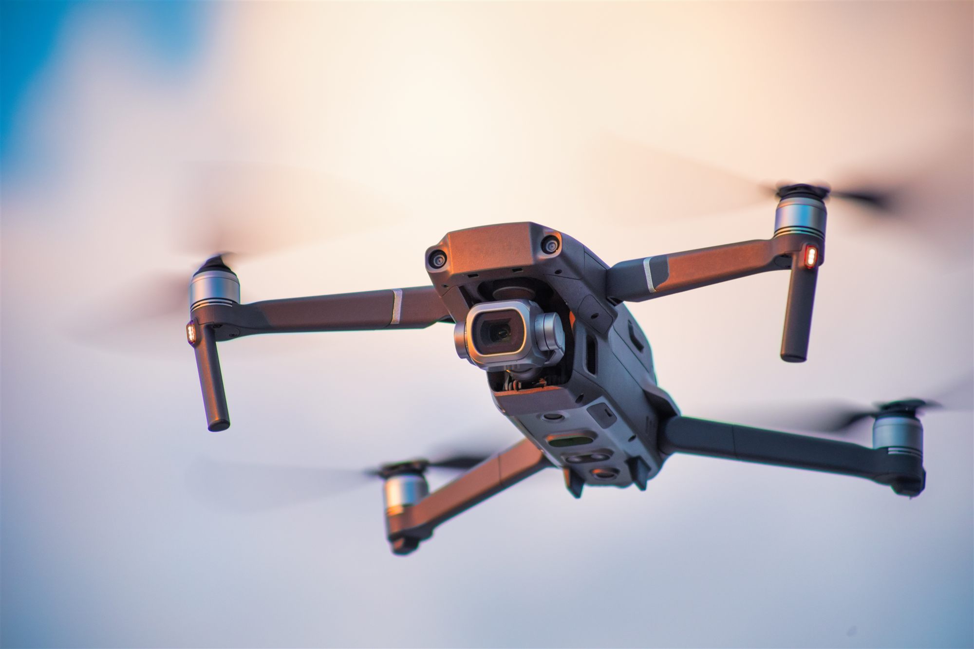 Drone flying against a sunset sky